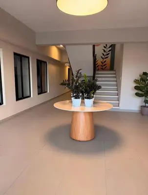 a lobby with a table with two potted plants on it at Relaxing & New Retreat 3 bedroom riviera Verde in Santo Domingo