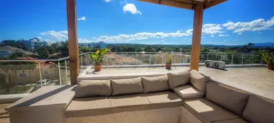 a large living room with a couch on a balcony at Villa Jasmine Ocean Village in Sosúa