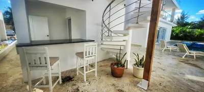 a room with two chairs and a spiral staircase at Apt Jasmine Ocean Village in Sosúa