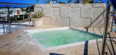 a hot tub on the roof of a house at Apt Jasmine Ocean Village in Sosúa