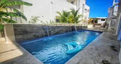 a swimming pool with a slide in the middle at Apt Jasmine Ocean Village in Sosúa