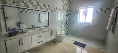 a bathroom with a sink and a mirror and a shower at Apt Jasmine Ocean Village in Sosúa