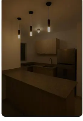 a kitchen with a counter top and a refrigerator at Apartamento cerca del aeropuerto y la playa in San Isidro