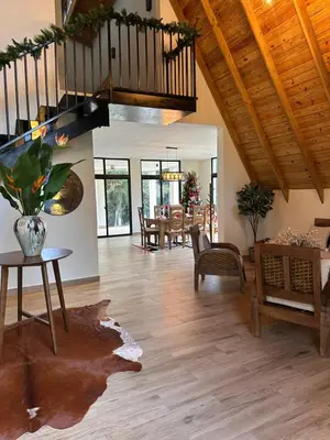 a large living room with a wooden ceiling at La Gloria in San José de Ocoa
