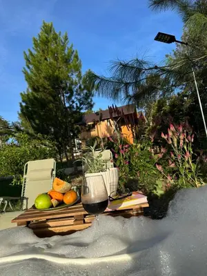 a table with a plate of fruit and a glass of wine at La Gloria in San José de Ocoa