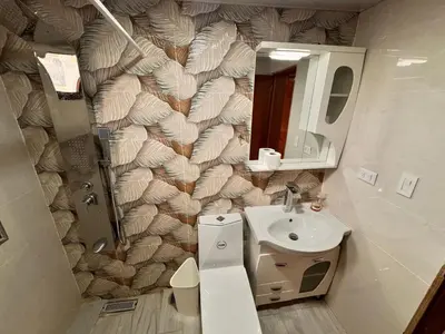 a bathroom with a toilet and a sink and a mirror at Enjoy Huge 4 bedrooms and 3 bathrooms in Santiago de los Caballeros