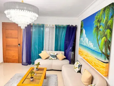 a living room with a painting on the wall at NEW 8apts enjoy HUGE 4 bedrs in Santiago de los Caballeros
