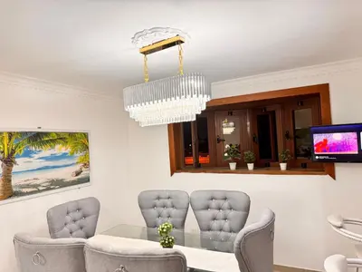 a dining room with chairs and a chandelier at NEW 8apts enjoy HUGE 4 bedrs in Santiago de los Caballeros