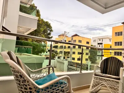 a balcony with chairs and a view of buildings at NEW 8apts enjoy HUGE 4 bedrs in Santiago de los Caballeros