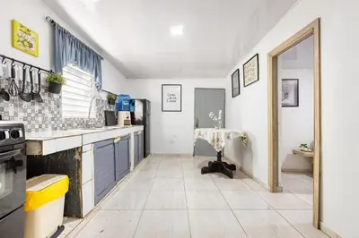 a kitchen with a sink and a table in it at Casa de las Mariposas - near the beach in Río San Juan