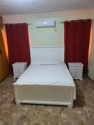 a bedroom with a white bed and red curtains at Apartahotel Henry Winche in Sabana Grande de Boyá