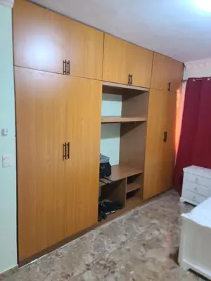 a closet in a room with wooden cabinets at Apartahotel Henry Winche in Sabana Grande de Boyá
