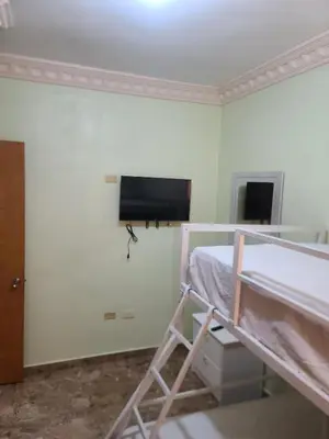 a bedroom with a bunk bed and a flat screen tv at Apartahotel Henry Winche in Sabana Grande de Boyá