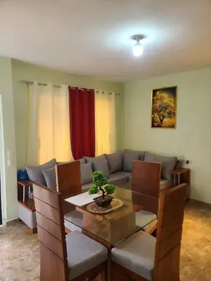 a living room with a table and a couch at Apartahotel Henry Winche in Sabana Grande de Boyá