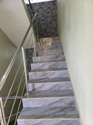 a staircase with metal railings and a brick wall at Apartahotel Henry Winche in Sabana Grande de Boyá