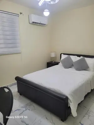 a bedroom with a large bed with white sheets and pillows at bienvenido a casa in San Pedro de Macorís