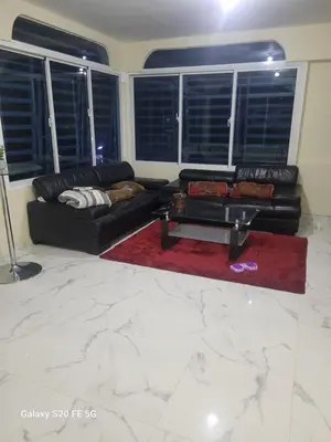 a living room with a black couch and a red rug at bienvenido a casa in San Pedro de Macorís