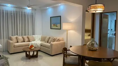 a living room with a couch and a table at Apartamento San Pedro Colonial in San Pedro de Macorís