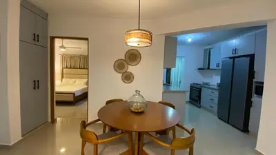 a kitchen and dining room with a table and chairs at Apartamento San Pedro Colonial in San Pedro de Macorís