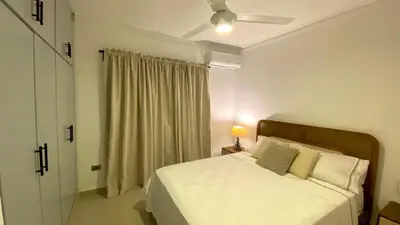 a bedroom with a white bed and a window at Apartamento San Pedro Colonial in San Pedro de Macorís