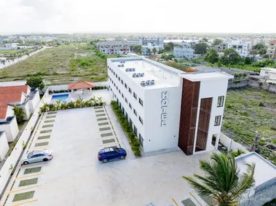 an overhead view of a white building with a car parked in front at Hotel Stars Bávaro hab 102 in Punta Cana