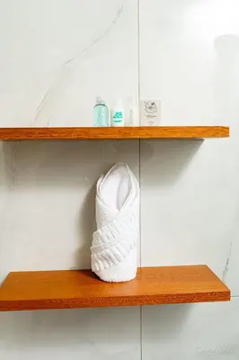 a pair of white shoes sitting on a wooden shelf at Hotel Stars Bávaro hab 102 in Punta Cana