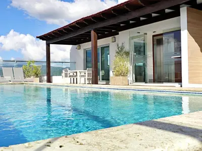 a swimming pool in front of a house at Soha Suites II Deluxe in Colorado