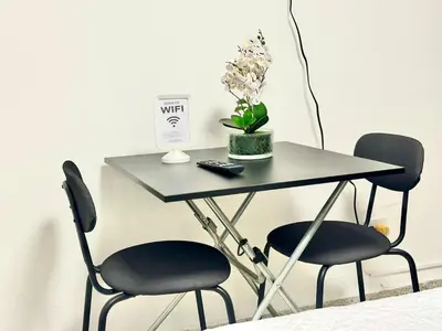a table with two chairs and a table with a plant on it at Mini Hogar Céntrico in Santiago de los Caballeros