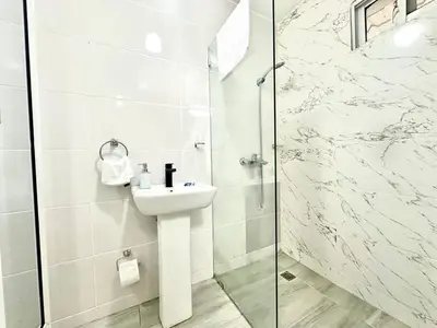 a bathroom with a sink and a shower at Mini Hogar Céntrico in Santiago de los Caballeros