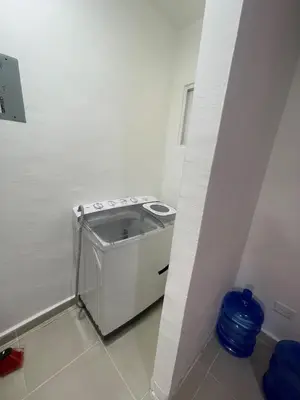 a small kitchen with a washing machine in a room at Beautifull and Luxe Apartment 10 mn to the Int Airport in Los Paredones