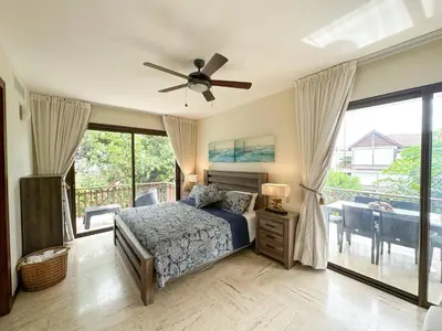 a bedroom with a bed and a ceiling fan at Portillo Residences, El Limon, Luxury Apartment in El Limón