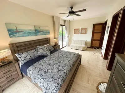 a bedroom with a bed and a ceiling fan at Portillo Residences, El Limon, Luxury Apartment in El Limón