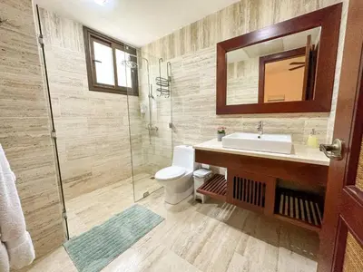 a bathroom with a toilet and a sink and a shower at Portillo Residences, El Limon, Luxury Apartment in El Limón