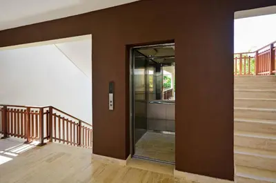 a hallway with stairs and a glass door at Portillo Residences, El Limon, Luxury Apartment in El Limón