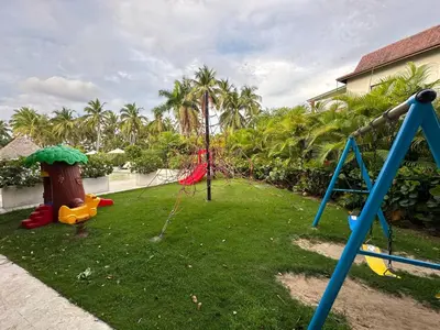 a playground with swings in a yard with palm trees at Portillo Residences, El Limon, Luxury Apartment in El Limón