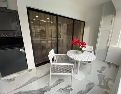 a small table and chairs in a room with a television at Crystal Pool Oasis in Sosúa