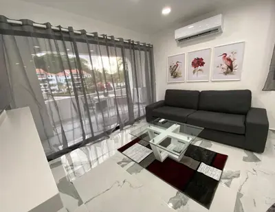 a living room with a couch and a glass table at Crystal Pool Oasis in Sosúa