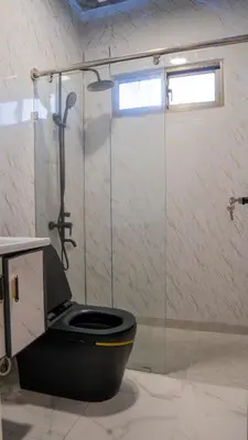 a bathroom with a toilet and a glass shower at Villas Escape in Las Terrenas