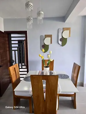 a dining room with a table and chairs at Hermoso Alojamiento con Terraza y Jacuzzi en Santiago in Santiago de los Caballeros