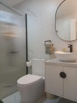 a bathroom with a toilet and a sink and a mirror at Downtown, Cozy and Modern! in Santo Domingo
