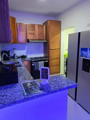 a kitchen with a counter with a tablet on it at Luxury Apartment in Boca Chica in La Julia