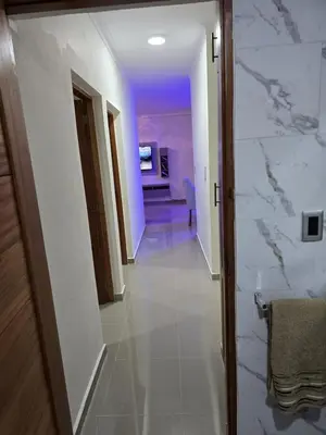 a hallway with a white tile floor and a room at Luxury Apartment in Boca Chica in La Julia