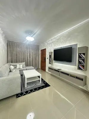 a living room with a couch and a flat screen tv at Luxury Apartment in Boca Chica in La Julia