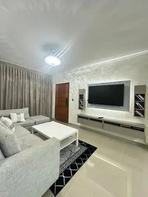 a living room with a couch and a flat screen tv at Luxury Apartment in Boca Chica in La Julia