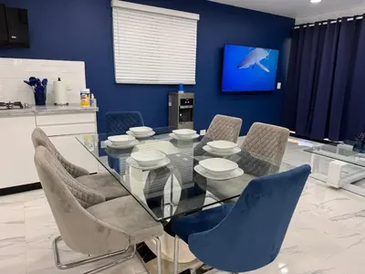 a dining room with a glass table and chairs at Blue Oasis Luxury in Sosúa