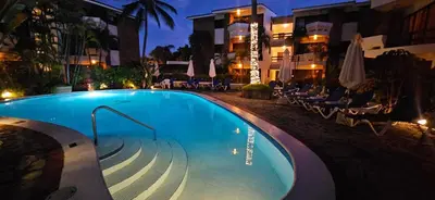 a swimming pool at a hotel at night at Blue Oasis Luxury in Sosúa