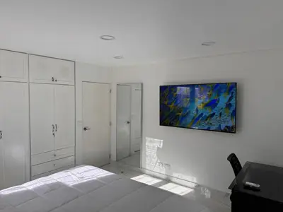 a bedroom with a bed and a painting on the wall at Blue Oasis Luxury in Sosúa
