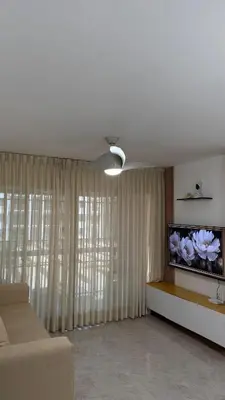 a living room with a couch and a flat screen tv at New and Comfortable Apartment in Ciudad Juan Bosch in San Isidro
