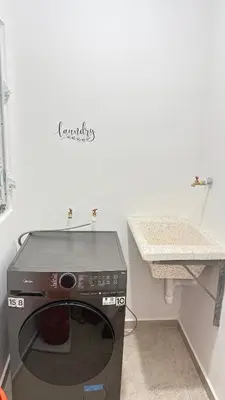 a microwave in a kitchen with a counter and a sink at New and Comfortable Apartment in Ciudad Juan Bosch in San Isidro