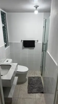 a bathroom with a toilet and a sink and a shower at New and Comfortable Apartment in Ciudad Juan Bosch in San Isidro